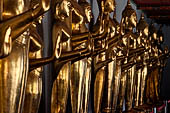 Bangkok Wat Pho, Buddha gilded statues lined in the double cloister enclosing the ubosot.  